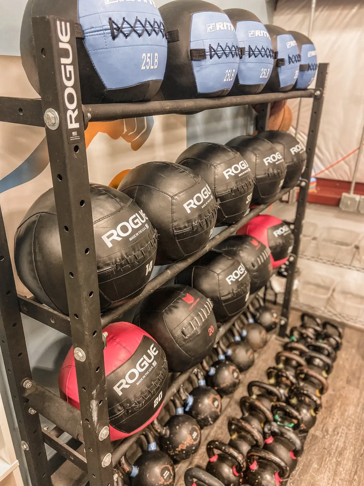 Rack of medicine balls and kettlebells