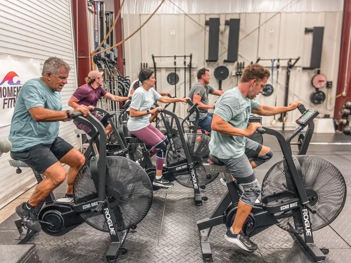 Members warming up on assault bikes